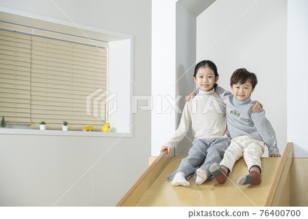 Asian siblings on the slide Asian siblings on the slide 76400700
