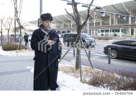 Asian man with smartphone 76400704