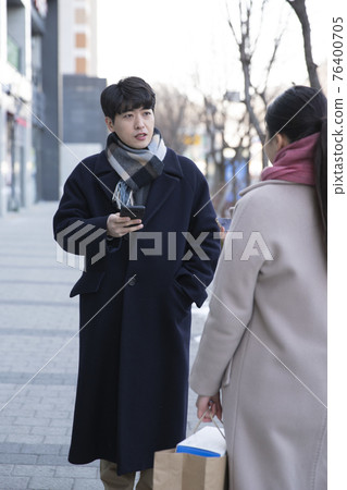 Asian man and female person on street Asian man and female person on street 76400705