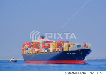 A large container ship entering the port of Osaka 76401156
