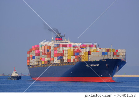A large container ship entering the port of Osaka 76401158