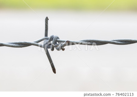 background textured barbed wire of fence for safe at home  76402113