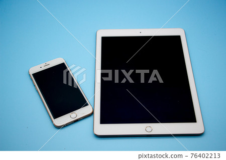Blue background and two electronic devices, tablet and smartphone 76402213