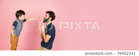 Happy man and little boy, father and son isolated over pink background. 76402341