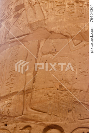 Ancient Egyptian fertility god Min carved on column in Great Hypostyle Hall in Karnak temple complex in Luxor, Egypt 76404364