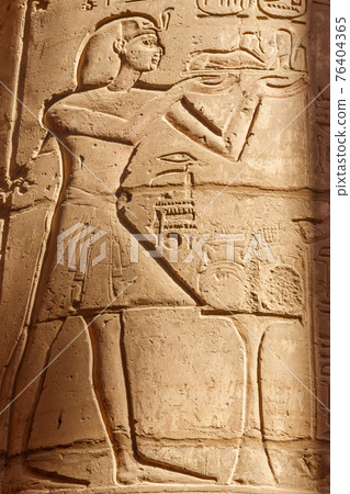 Ancient egyptian paintings and hieroglyphs on the wall in Karnak Temple Complex in Luxor, Egypt Ancient egyptian paintings and hieroglyphs on the wall in Karnak Temple Complex in Luxor, Egypt 76404365