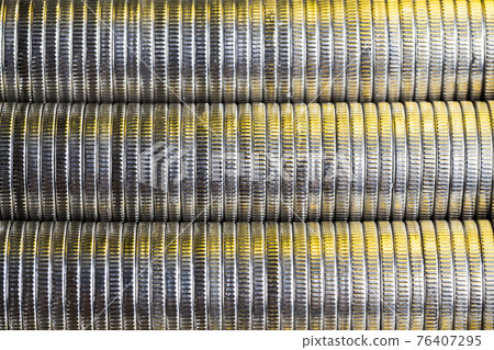 many round metal coins of silver color illuminated with Golden color many round metal coins of silver color illuminated with Golden color 76407295