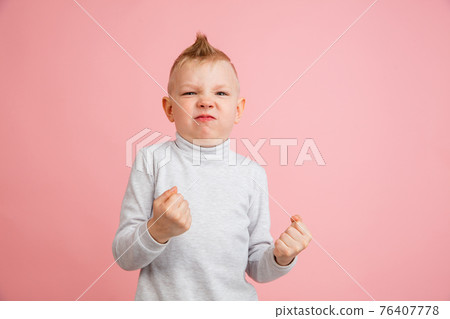 Happy boy isolated on pink studio background. Looks happy, cheerful, sincere. Copyspace. Childhood, education, emotions concept Happy boy isolated on pink studio background. Looks happy, cheerful, sincere. Copyspace. Childhood, education, emotions concept 76407778