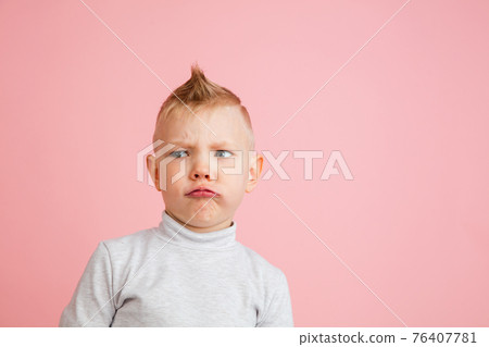 Happy boy isolated on pink studio background. Looks happy, cheerful, sincere. Copyspace. Childhood, education, emotions concept Happy boy isolated on pink studio background. Looks happy, cheerful, sincere. Copyspace. Childhood, education, emotions concept 76407781