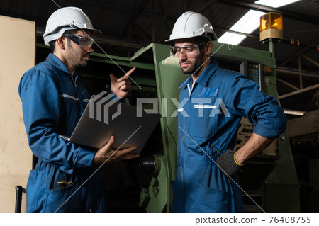 Group of skillful factory workers using machine equipment in workshop Group of skillful factory workers using machine equipment in workshop 76408755