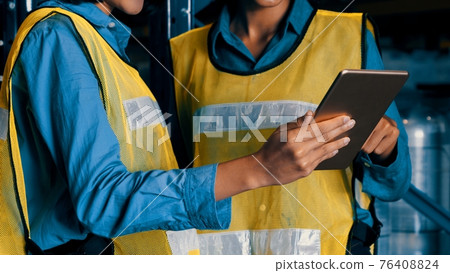 Female warehouse worker working at the storehouse 76408824