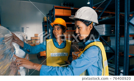 Female warehouse worker working at the storehouse Female warehouse worker working at the storehouse 76408920