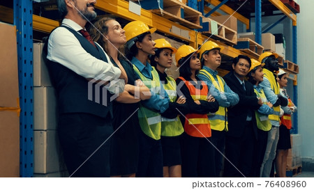 Large group of factory worker standing together in warehouse or storehouse Large group of factory worker standing together in warehouse or storehouse 76408960