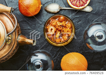 Orange fruit jam in stylish glass jar and fresh fruit Orange fruit jam in stylish glass jar and fresh fruit 76409528