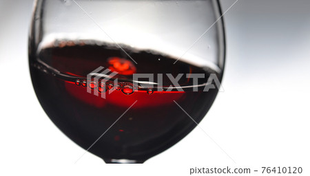 Red wine in wineglass. 76410120
