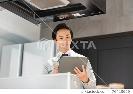 A businessman wearing work clothes to inspect the house 76410669