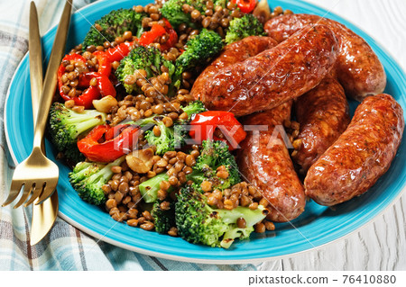 Italian sausages with lentils on a plate, top view 76410880