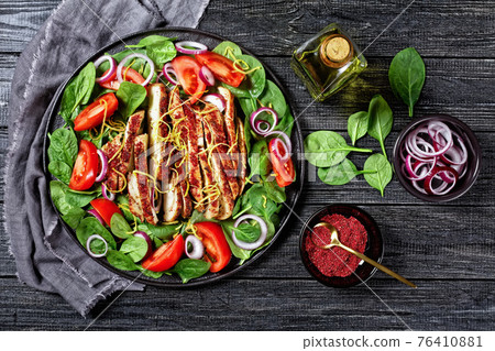 spinach tomato onion salad with chicken breast 76410881