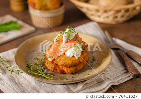 Delicious latkes with salmon 76411627