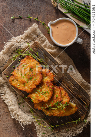 Homemade latkes with herbs 76411661