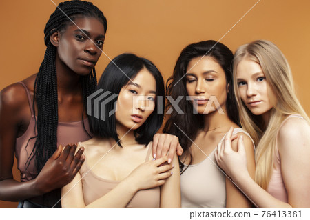 young pretty asian, caucasian, afro woman posing cheerful together on brown background, lifestyle diverse nationality people concept 76413381