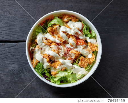 caesar salad on black wooden table caesar salad on black wooden table 76413439