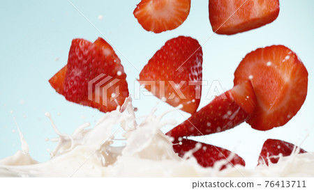 Strawberries falling into milk Strawberries falling into milk 76413711
