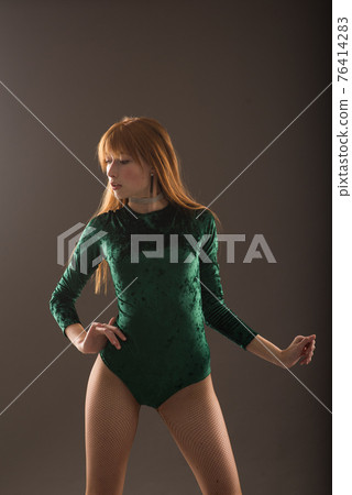 Young beautiful dancer posing in studio on grey background Young beautiful dancer posing in studio on grey background 76414283