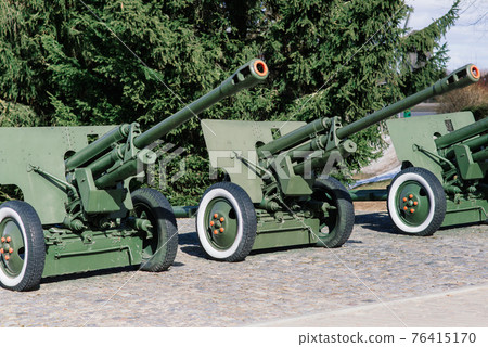 View of the russian cannons and howitzers in a park. Military museum outdoors View of the russian cannons and howitzers in a park. Military museum outdoors 76415170