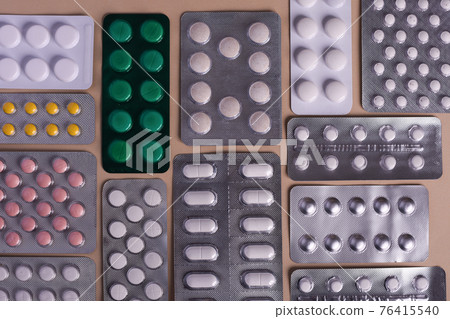 Pill tablets in a blister pack. Lots of flu medications.  76415540
