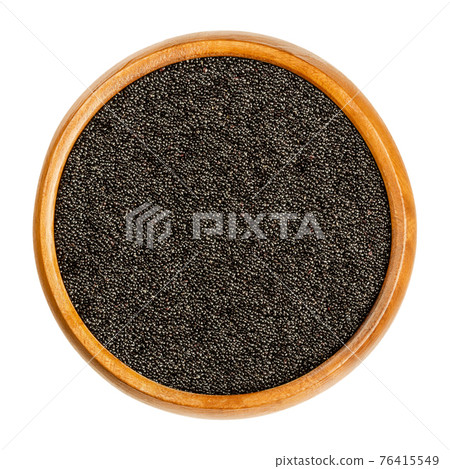 Black amaranth grain in a wooden bowl. Seeds of Amaranthus, a pseudocereal, staple food and source of protein of the Aztecs, banned by conquistadors. Close-up from above, over white, macro food photo. Black amaranth grain in a wooden bowl. Seeds of Amaranthus, a pseudocereal, staple food and source of protein of the Aztecs, banned by conquistadors. Close-up from above, over white, macro food photo. 76415549