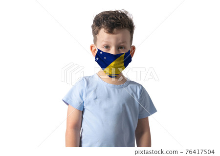 Respirator with flag of Tokelau. White boy puts on medical face mask isolated on white background Respirator with flag of Tokelau. White boy puts on medical face mask isolated on white background 76417504