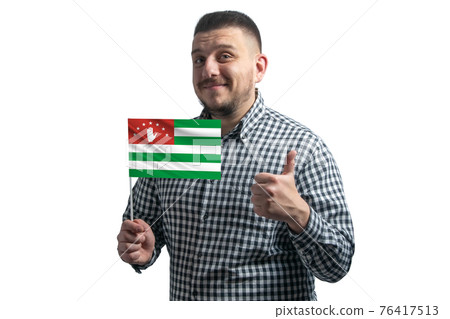White guy holding a flag of Abkhazia and shows the class by hand isolated on a white background. Like for Abkhazia White guy holding a flag of Abkhazia and shows the class by hand isolated on a white background. Like for Abkhazia 76417513