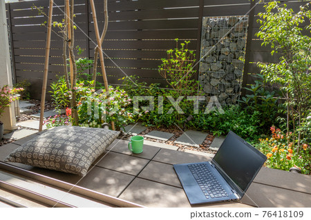 Telework image in a small garden with a gabion 76418109