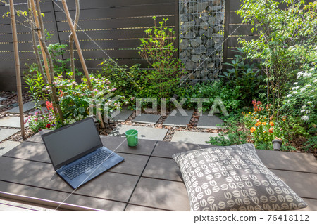 Telework image in a small garden with a gabion Telework image in a small garden with a gabion 76418112