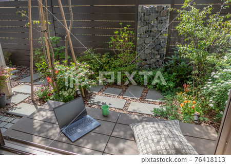 Telework image in a small garden with a gabion Telework image in a small garden with a gabion 76418113