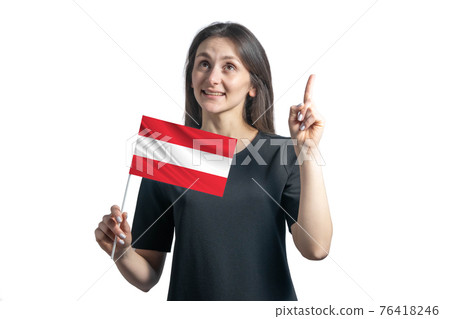 Happy young white woman holding flag of Austria and points thumbs up isolated on a white background 76418246