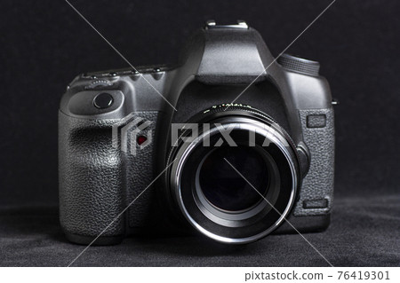 DSLR camera on black background DSLR camera on black background 76419301