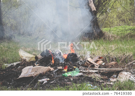 Cremation plastic garbage or trash in open fire. Damage to atmosphere 76419380