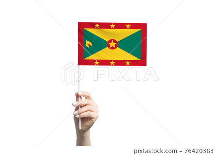 Beautiful female hand holding Grenada flag, isolated on white background 76420383