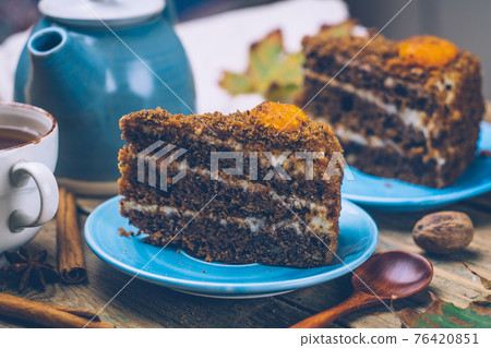 Carrot cake (homemade desserts) whith cinnamon sticks and decorated with spices and cup of tea on wooden background. Carrot cake (homemade desserts) whith cinnamon sticks and decorated with spices and cup of tea on wooden background. 76420851