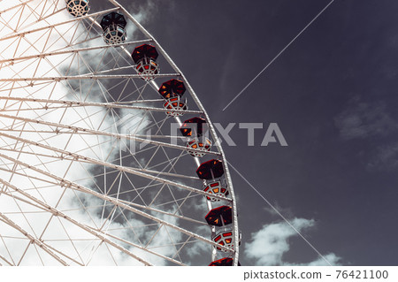 Ferris wheel in an amusement park.Blue sky. Copy space Ferris wheel in an amusement park.Blue sky. Copy space 76421100