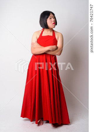 Full body shot of angry young gay Asian man looking upset 76421747