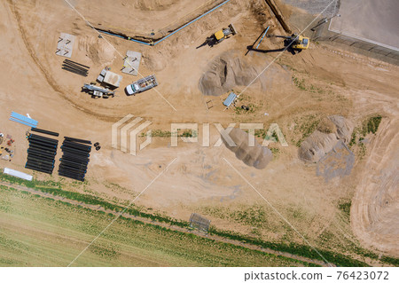 Aerial view new residential complex buildings for construction work in the laying pipes in the foundation 76423072