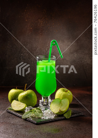 Delicious cold refreshing smoothie drink in cocktail glass with green apple Delicious cold refreshing smoothie drink in cocktail glass with green apple 76426196