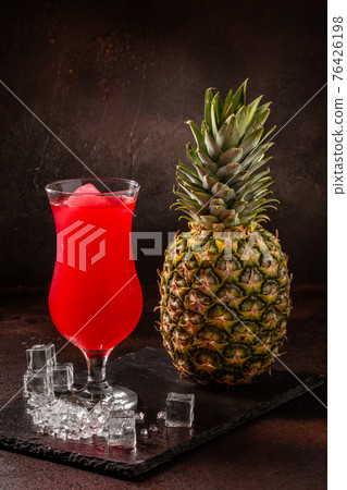 Delicious cold refreshing smoothie drink in cocktail glass with raspberry and ananas Delicious cold refreshing smoothie drink in cocktail glass with raspberry and ananas 76426198