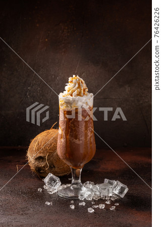 Delicious cold refreshing ice coffee in cocktail glass with coconut Delicious cold refreshing ice coffee in cocktail glass with coconut 76426226