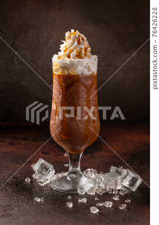 Delicious cold refreshing ice coffee in cocktail glass Delicious cold refreshing ice coffee in cocktail glass 76426228