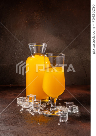 Delicious cold refreshing orange smoothie drink in cocktail glass 76426250