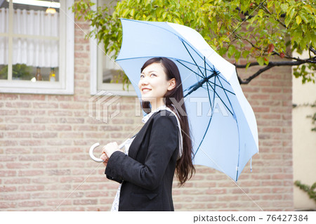A woman holding an umbrella A woman holding an umbrella 76427384